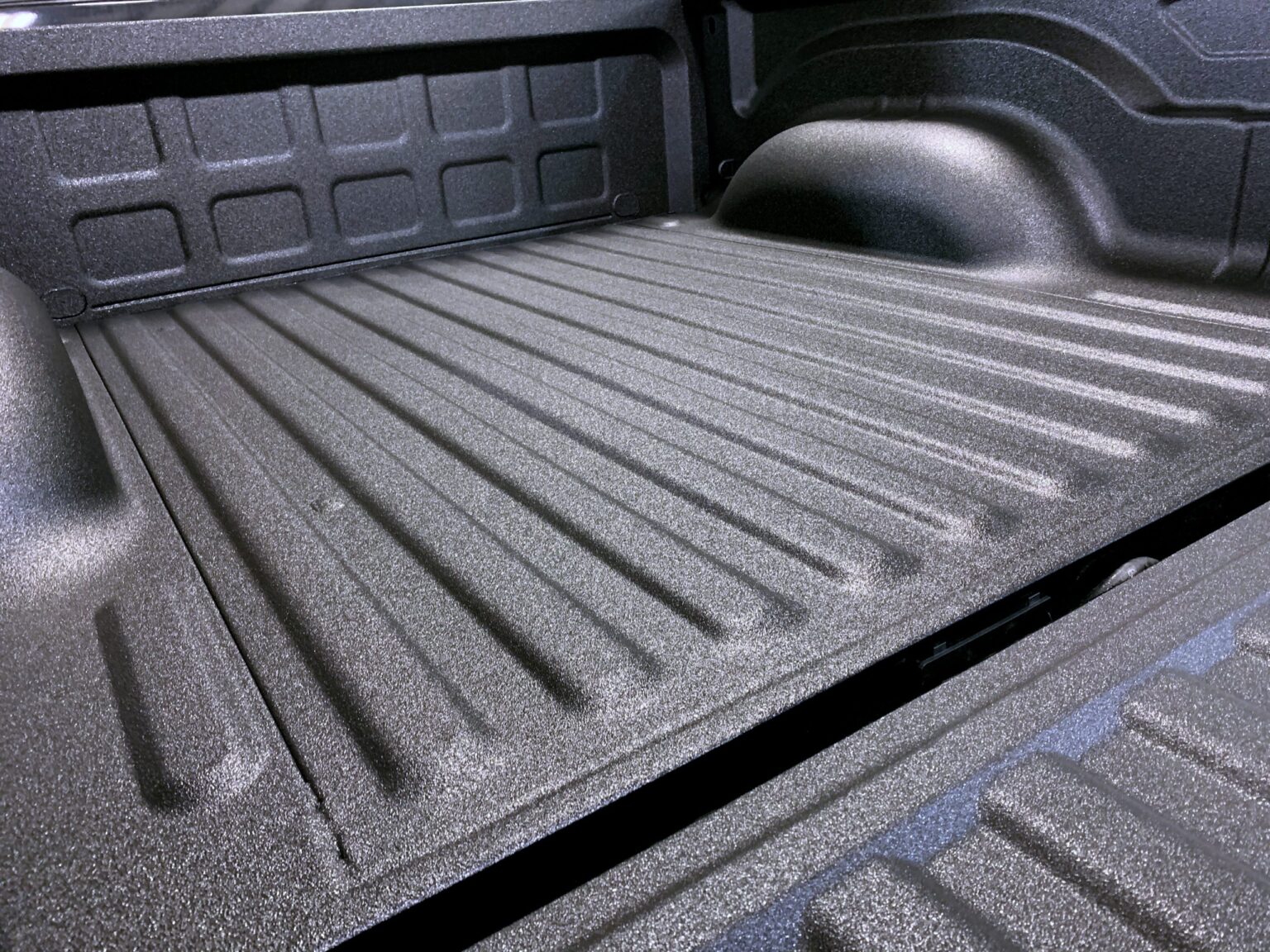 Close-up of a textured black polyurea truck bedliner